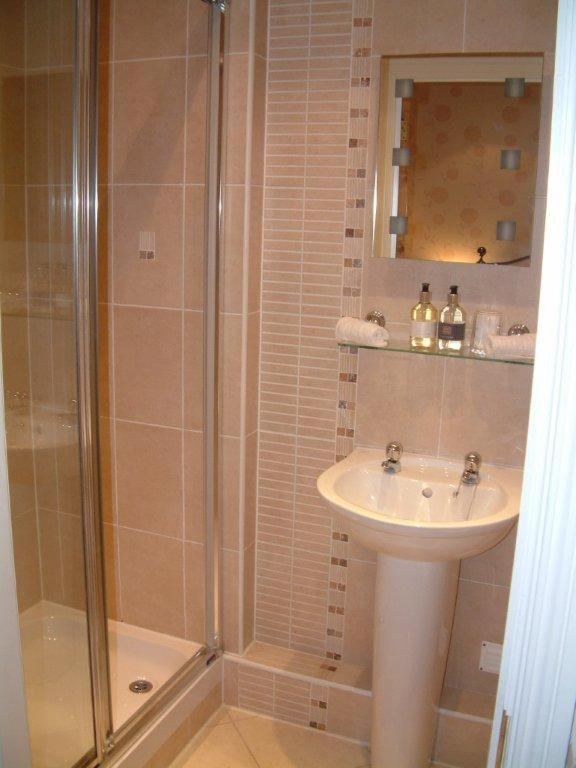 En suite bathroom with shower and pedestal basin